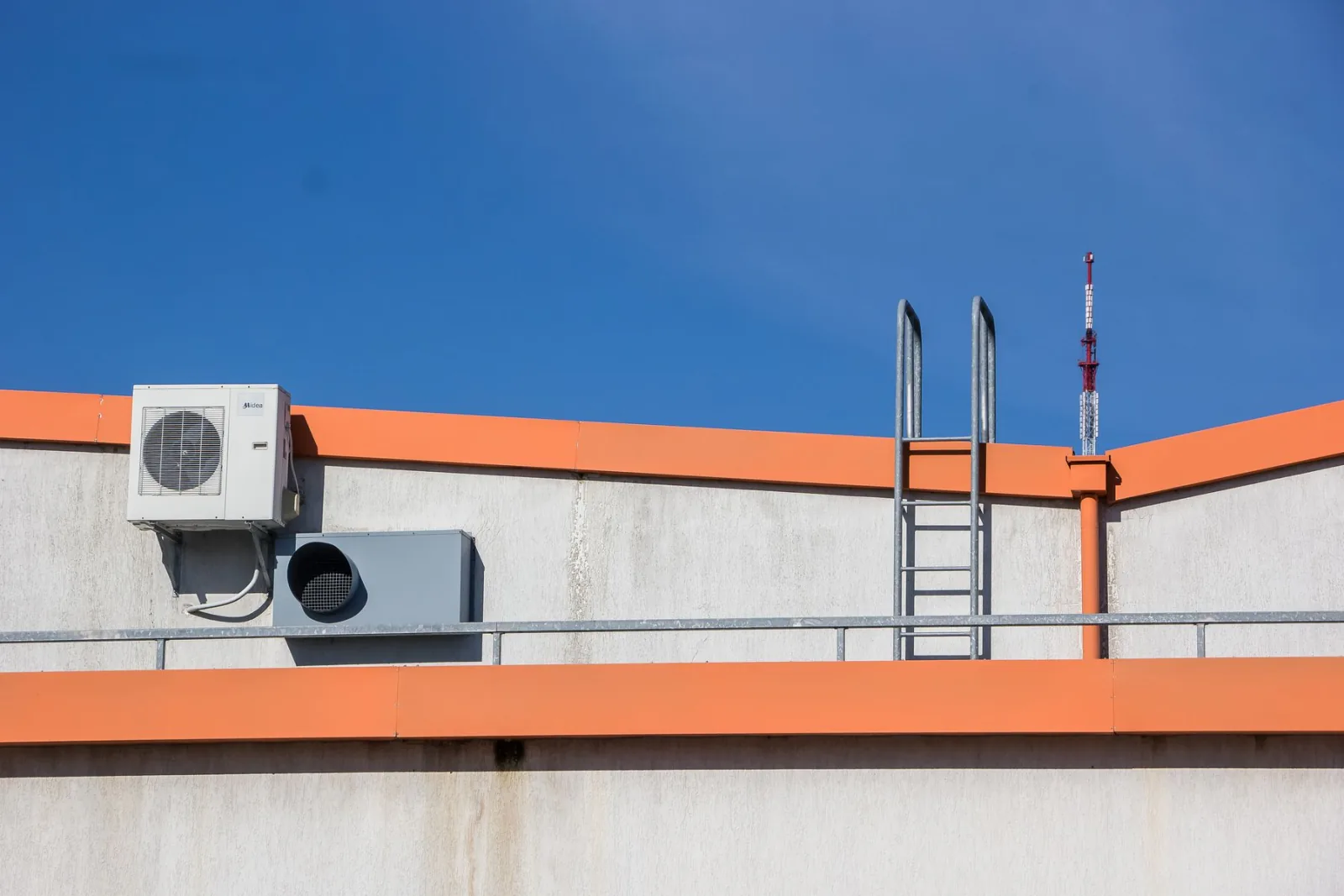 Rooftop air conditioning units against a blue sky.