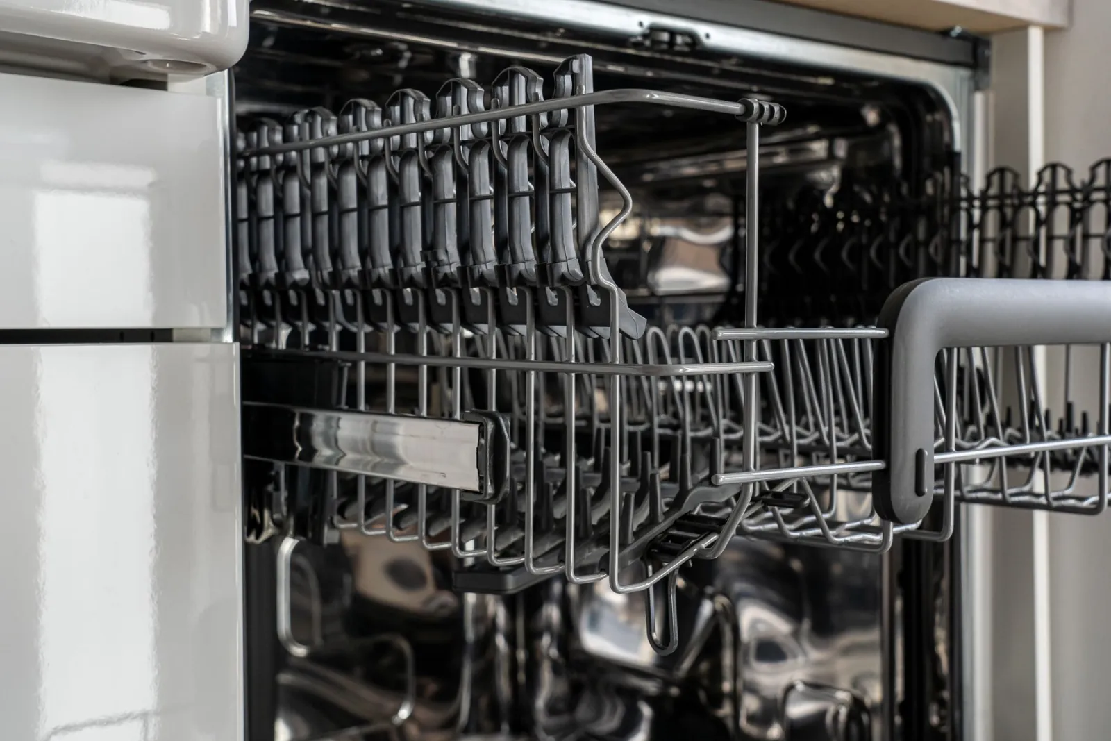 The interior of a commercial warewashing machine.