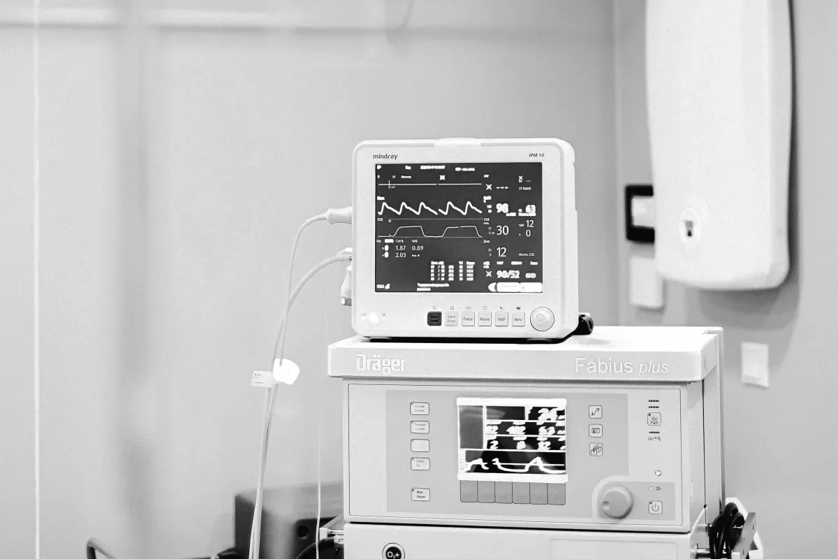 A patient monitor on an anesthesia machine in a clinical room.