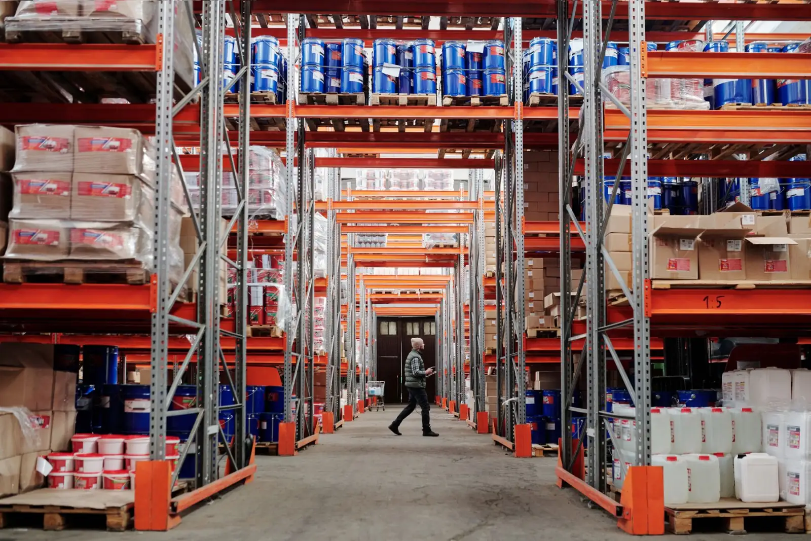 A bright warehouse aisle lined with racking.