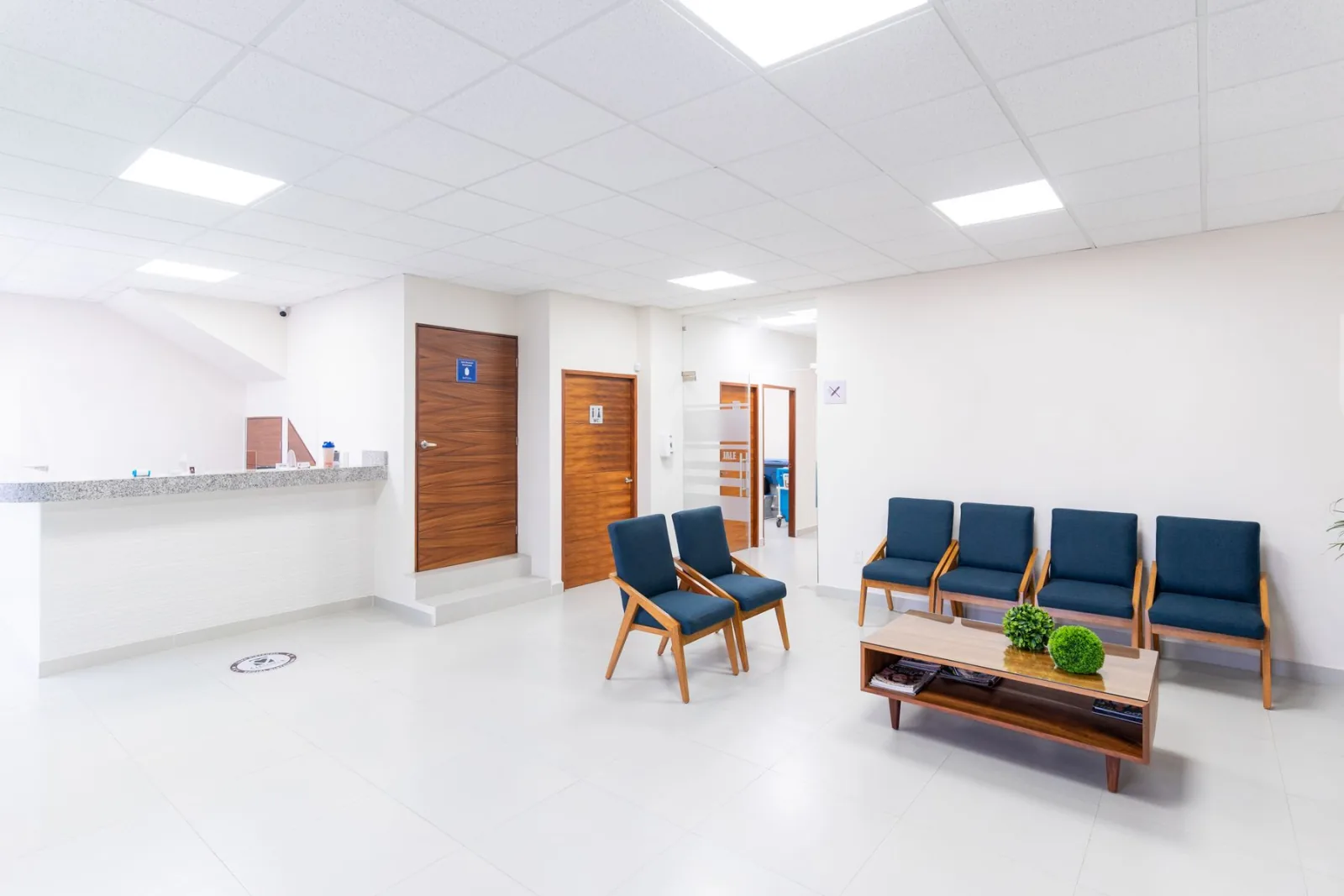 A clean clinic reception counter and waiting area.